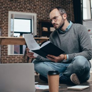 man reading a script at compouter